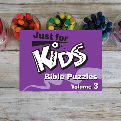 Children's Bible activies on a desk with crayons